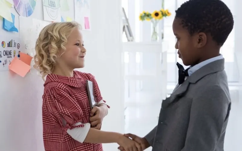 Two students shaking hands.
